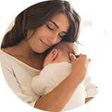 mother holding baby smiling