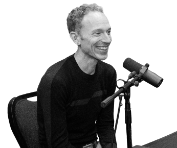podcast host talking into microphone