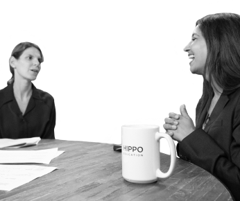 two women talking at a table